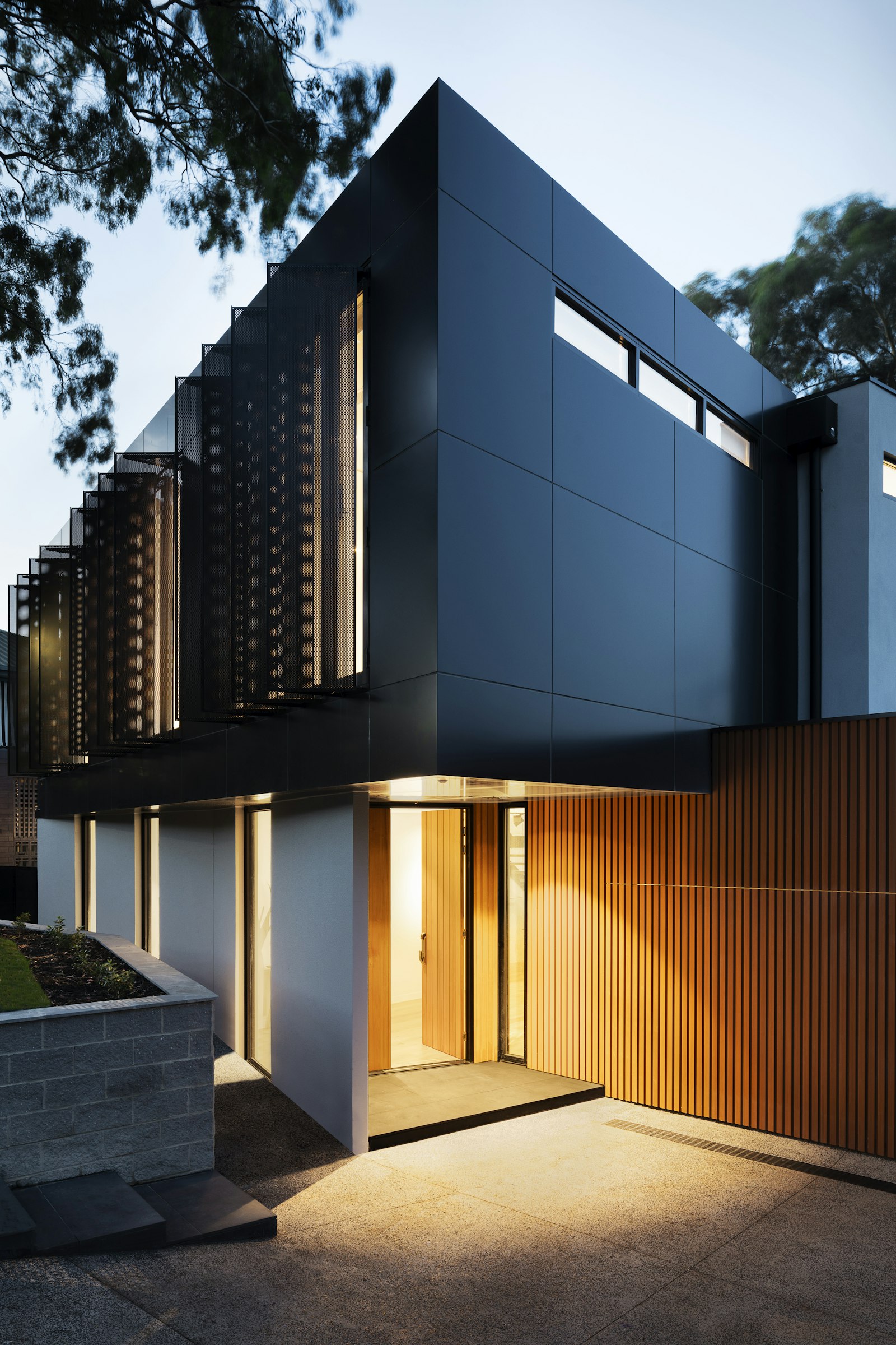 Wood, stone, and black metal at the entry of a custom home